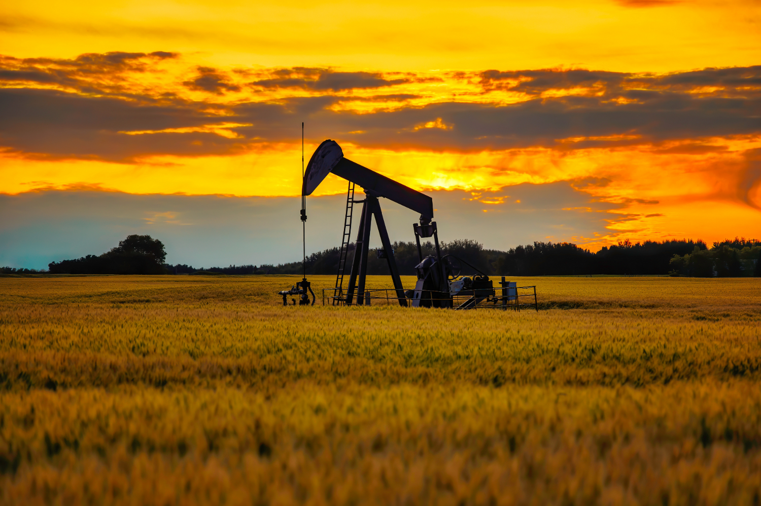 an abandoned oil well sits in a field, representing the need to seal orphaned wells to prevent methane leaks.