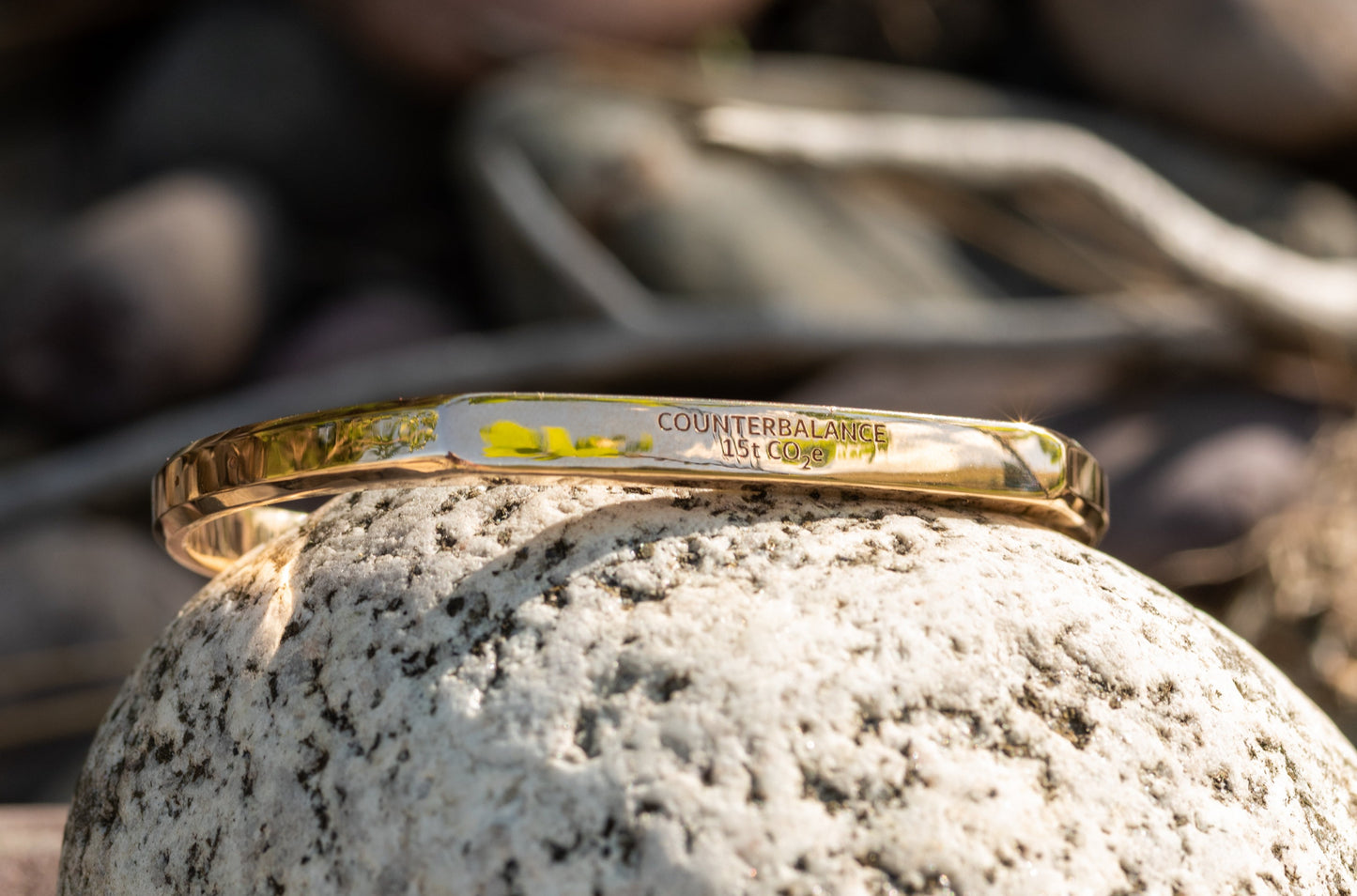 A 15 ton bronze Counterbalance bracelet displayed on a natural river rock in Missoula, Montana.