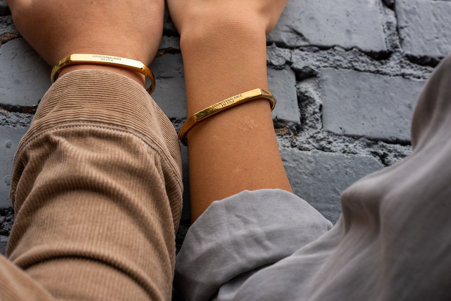 Two local Missoula models wearing Counterbalance bracelets in Gold and Bronze.