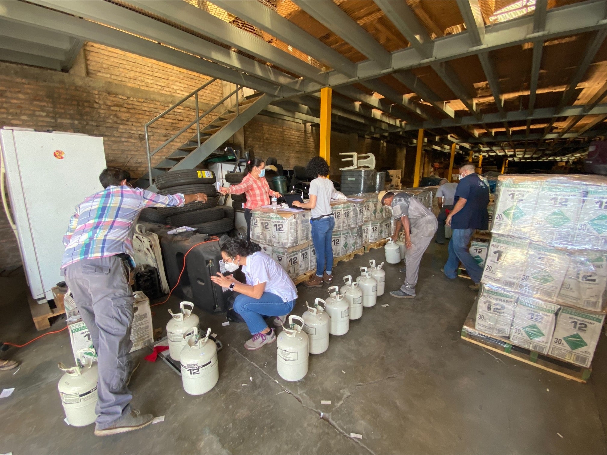 refrigerant gasses being inspected up by several people for proper disposal, photo provided by Tradewater. 