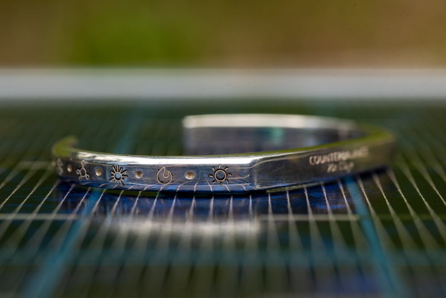 A 20t CO2e Counterbalance bracelet placed on a solar panel. 